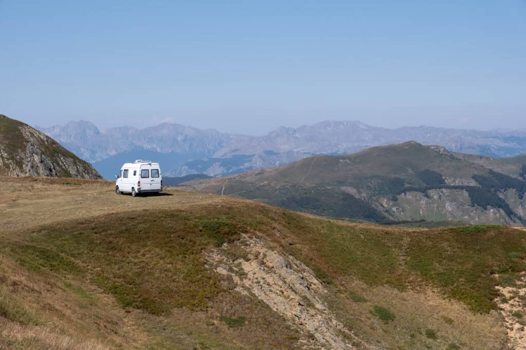 White camper van parked on top of the mountain with a great view over the valleys in Biogradska National Park, Montenegro