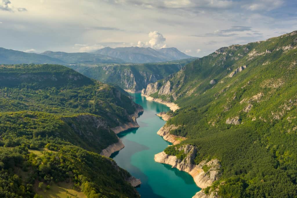 Aerial view of Beautiful Piva river canyon with reservoir Piva Lake (Pivsko Jezero) summer view in Montenegro. Nature travel background.